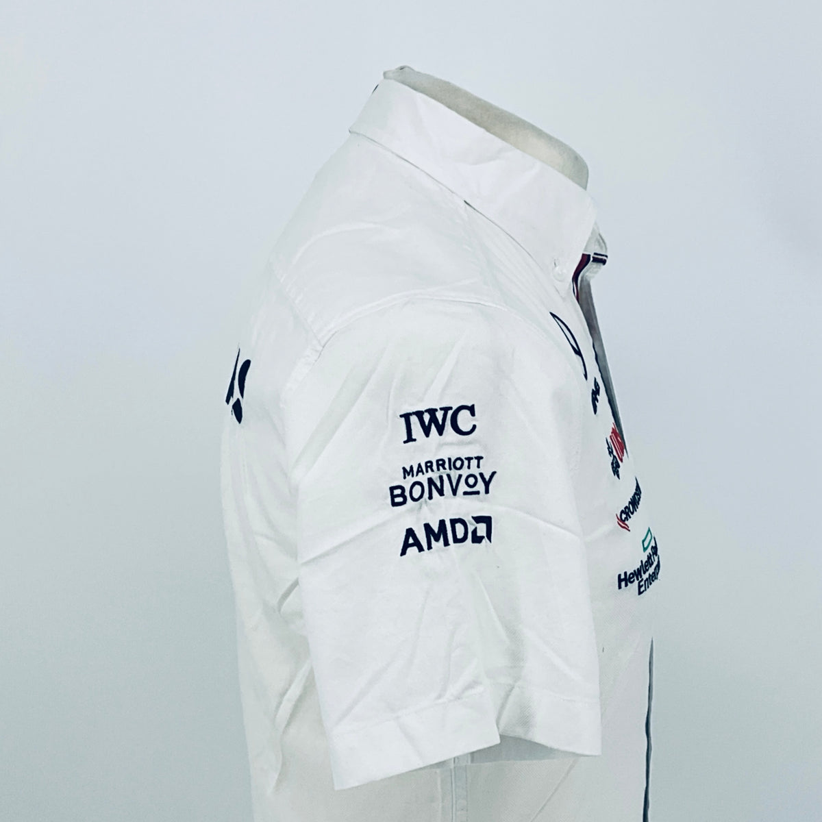 White team shirt sleeve with IWC, Marriott Bonvoy, and AMD logos