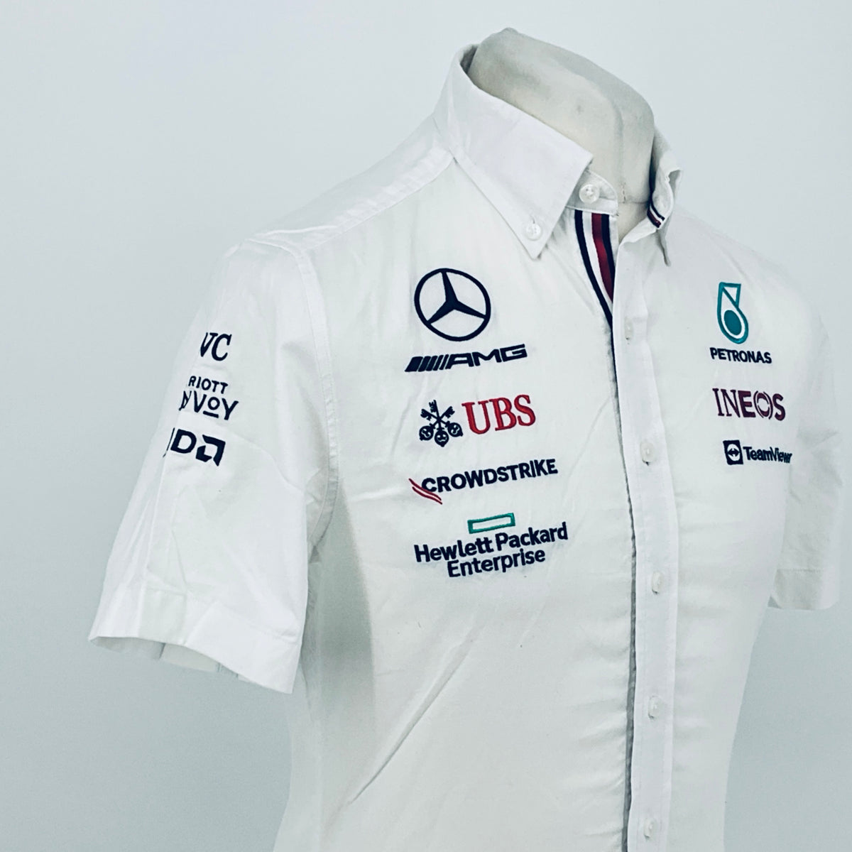White button-front team shirt with Mercedes-AMG, UBS, CrowdStrike, and INEOS logos