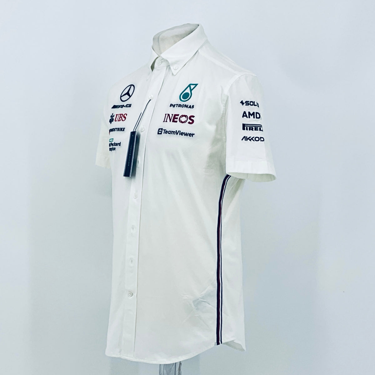 White short-sleeve team shirt angled view with button front, Petronas INEOS logo and navy trim
