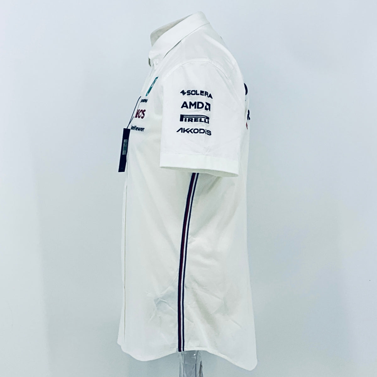 White team shirt sleeve side close-up with SOLERA, AMDA, PIRELLI, AKKODi logos and navy trim