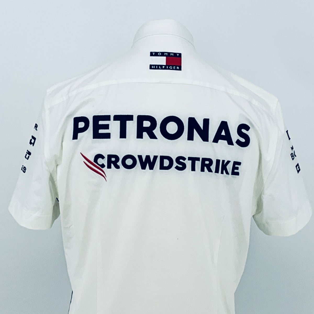 White back team shirt with PETRONAS CROWDSTRIKE; Tommy Hilfiger tag on the collar