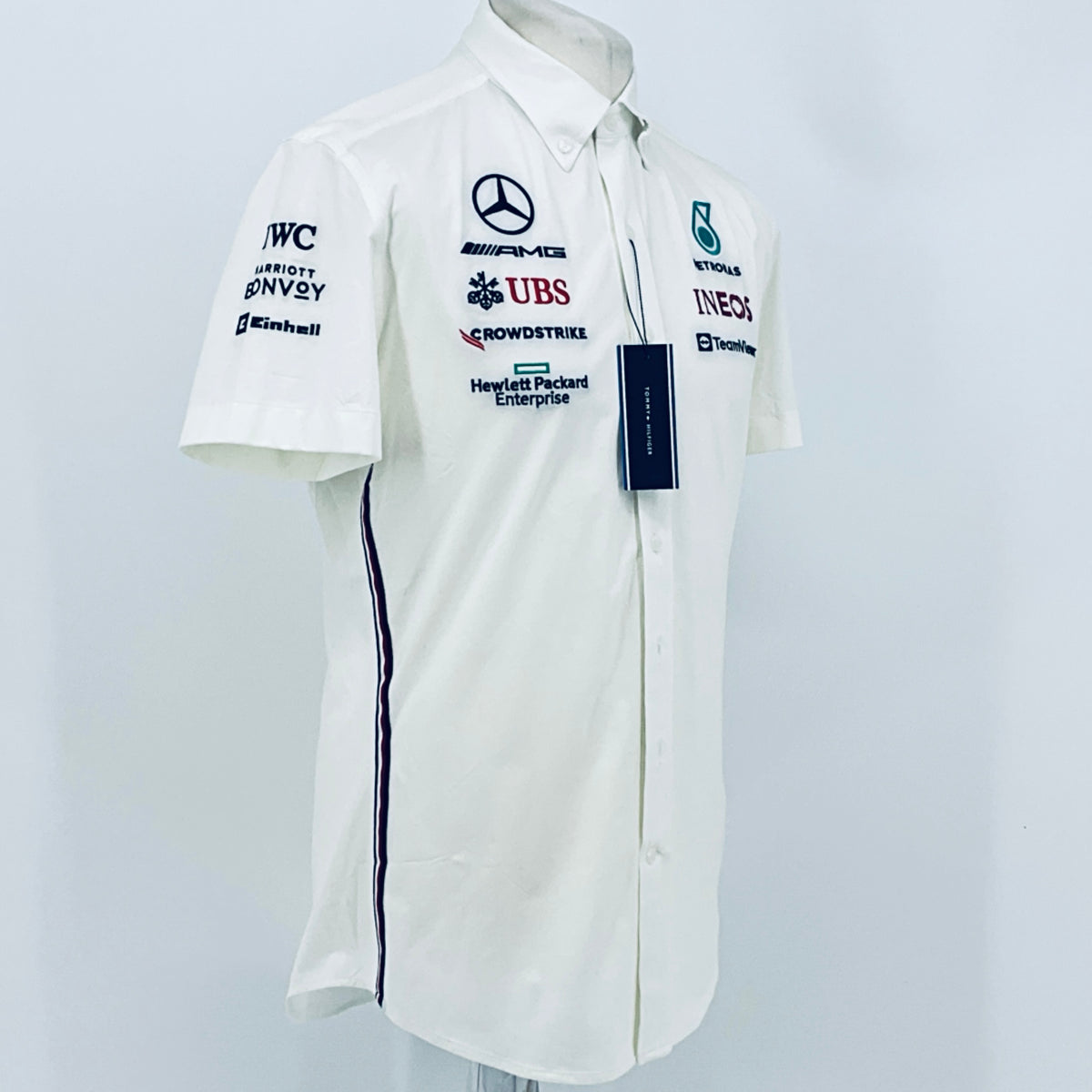 White team shirt with short sleeves and sponsor logos, button-front and collar