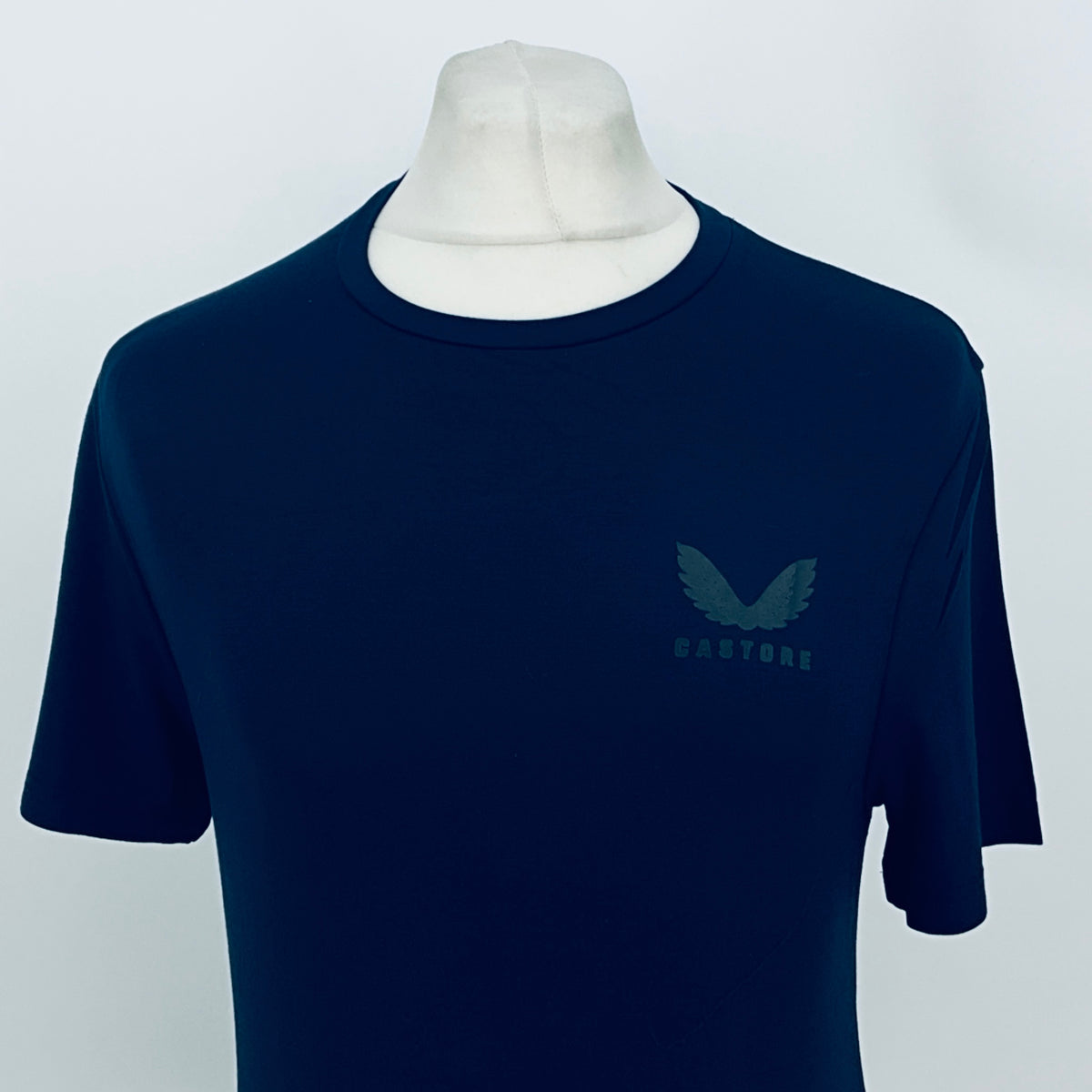 Men's navy Castore base layer T-shirt, front view with chest logo