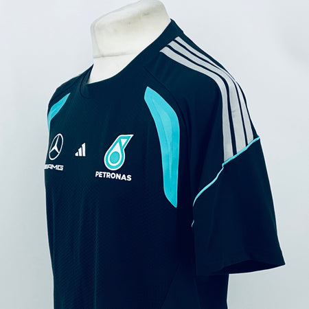 Navy F1 team t-shirt with white shoulder stripes and teal side swoosh graphic.