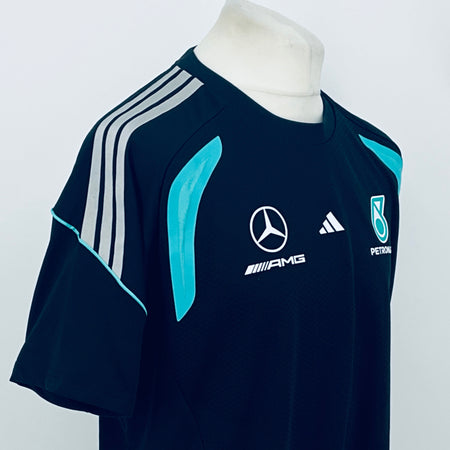Navy F1 team t-shirt with teal center graphic, Mercedes-AMG logo, and Petronas badge.
