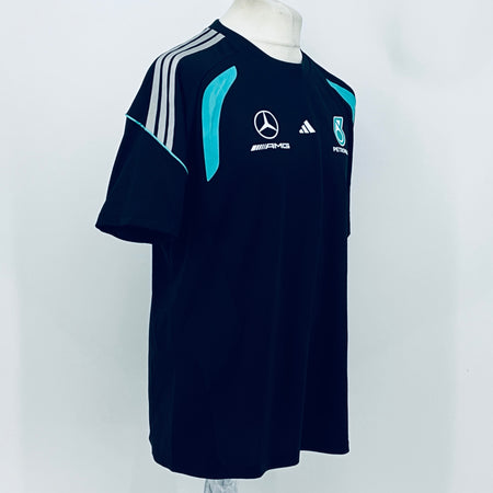 Navy F1 team t-shirt with white shoulder stripes and teal flame-style graphic.