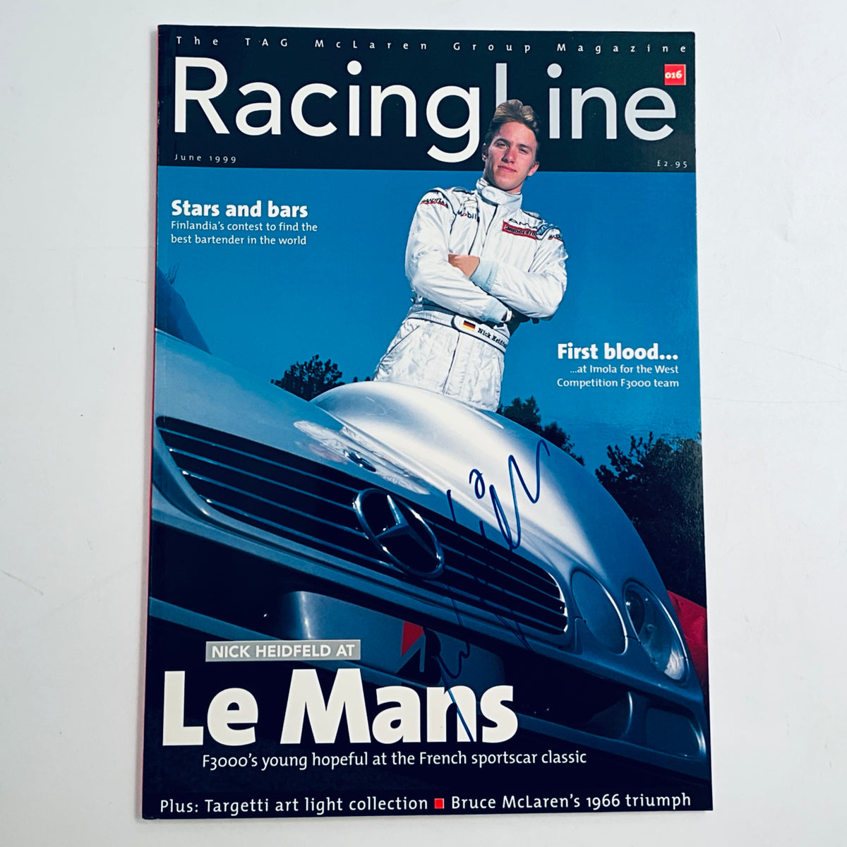 Racing magazine with photo of a driver and blue race car cover