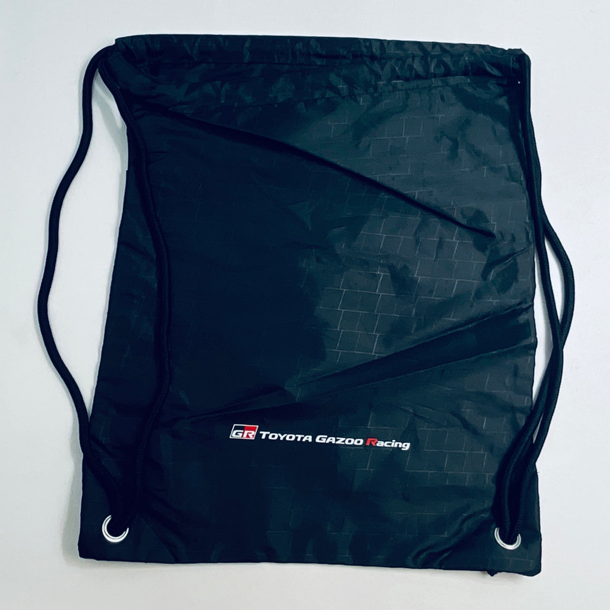 Dark drawstring bag with GR TOYOTA GAZOO Racing logo and metal eyelets