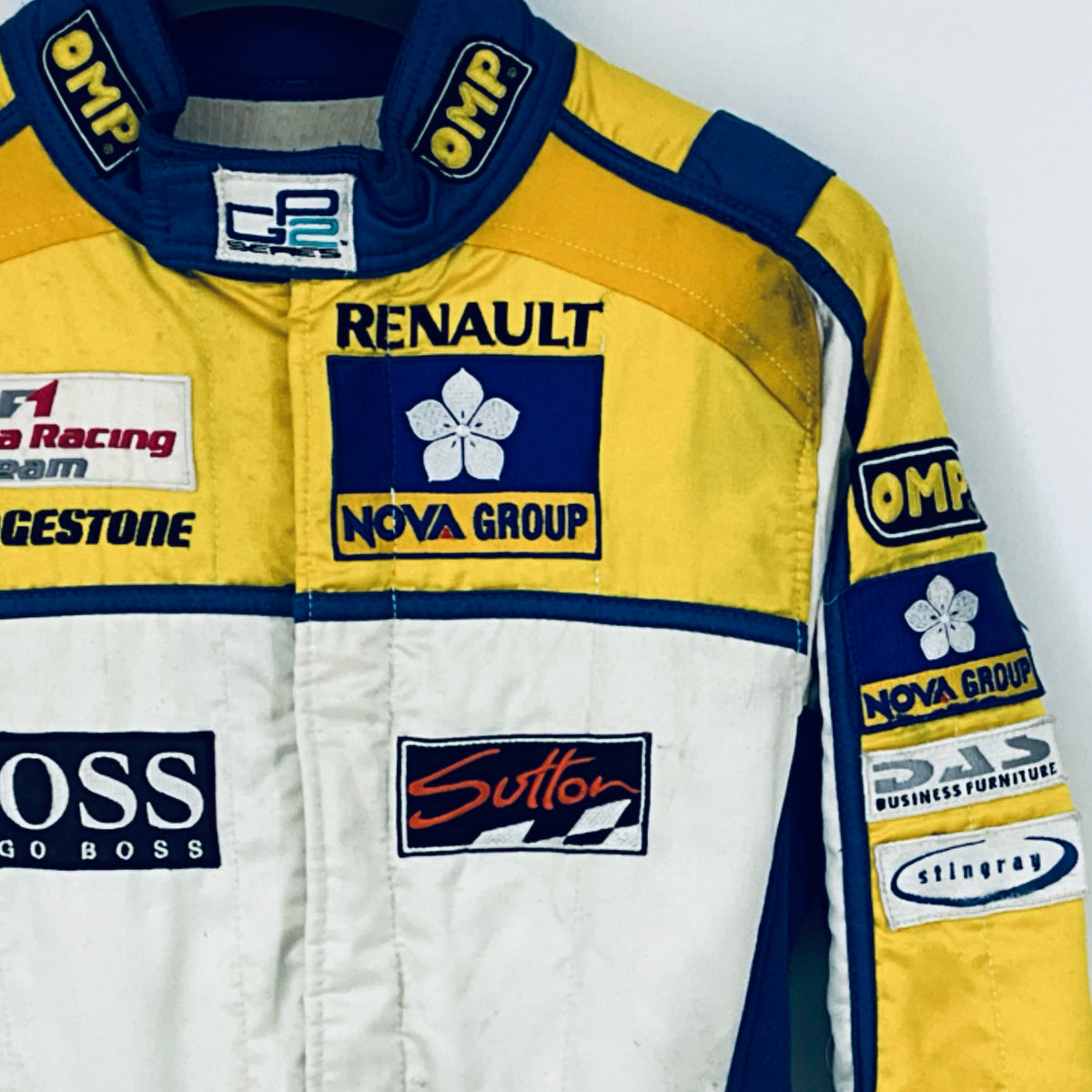Race driver suit chest logos with RENault and NOVA GROUP patches on yellow and white
