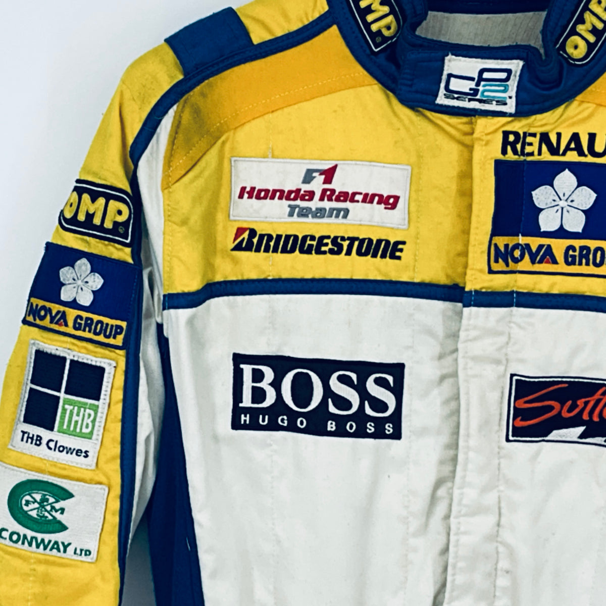 Race driver suit with large BOSS logo and yellow shoulder panel, blue trim
