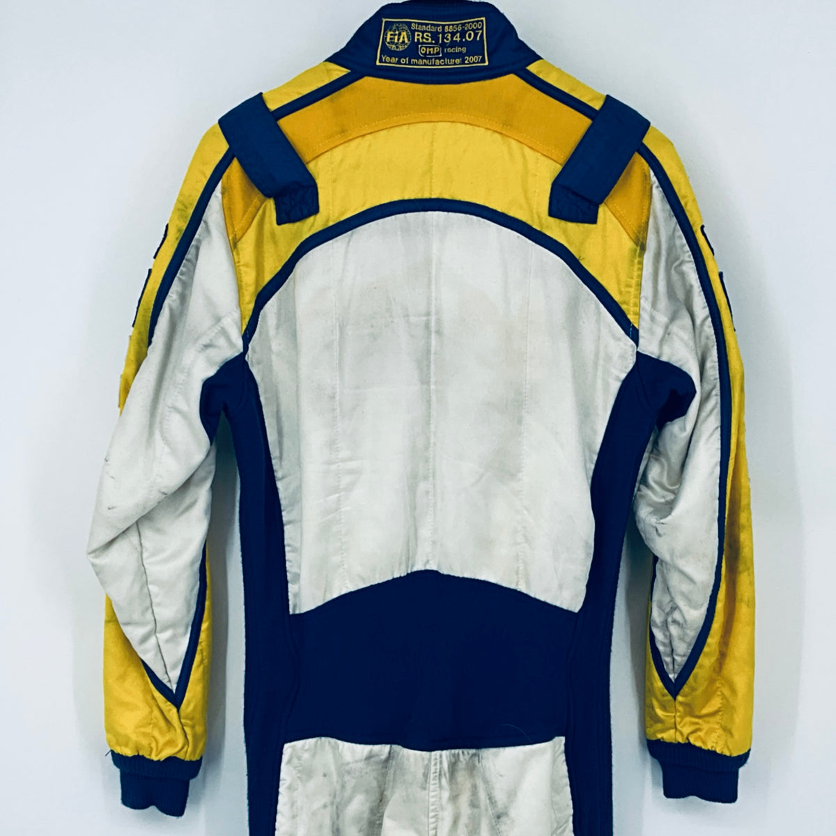 Back view of race driver suit with central white panel and blue lower section