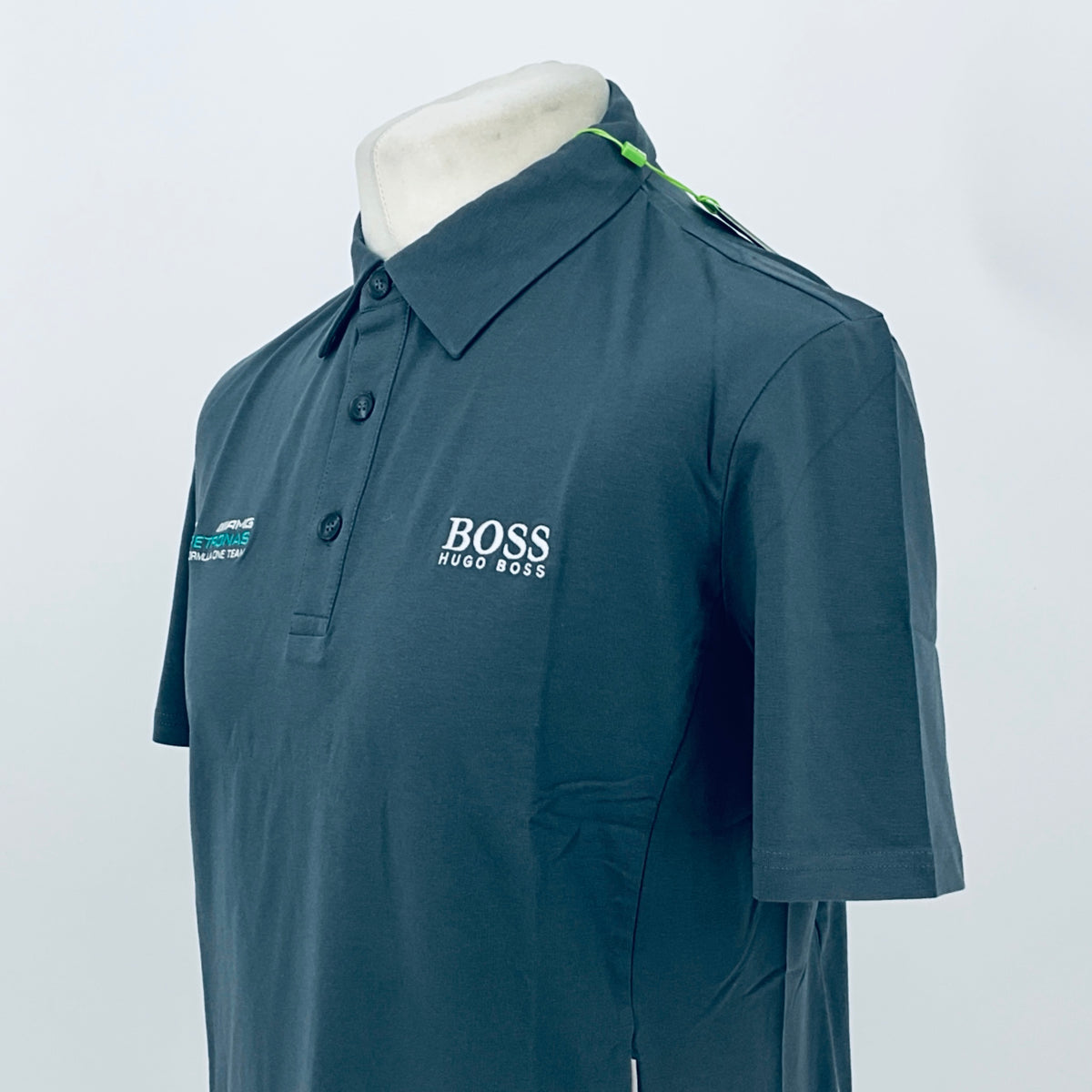 Boss polo shirt in dark teal, side view with chest “BOSS HUGO BOSS” logo