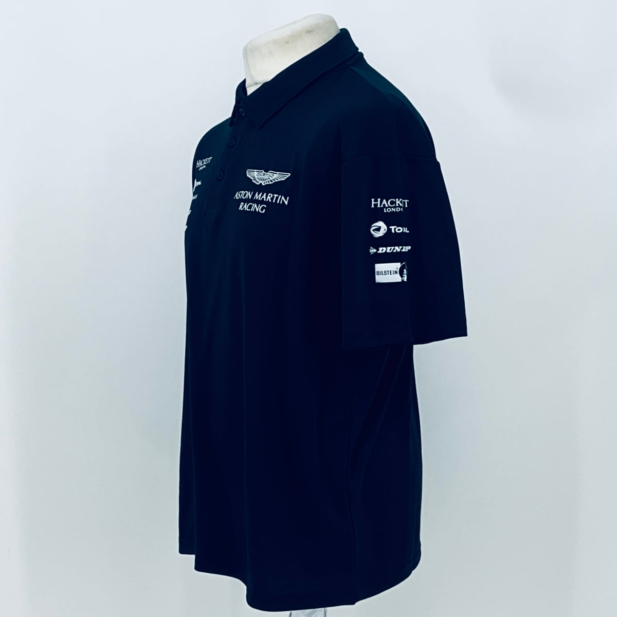 Navy Aston Martin Racing polo shirt with sleeve patch and chest logo embroidery.
