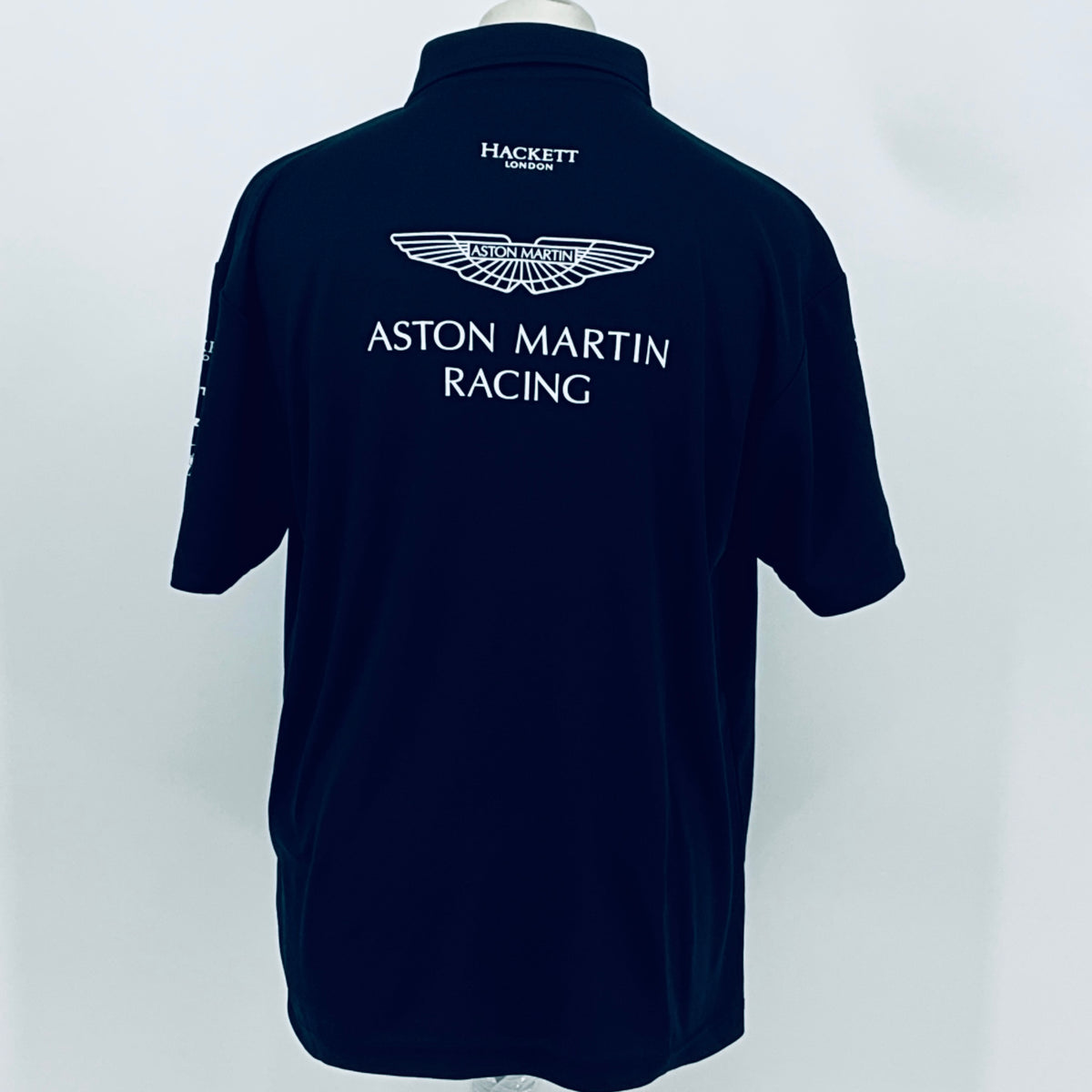Navy Aston Martin Racing polo shirt, back view with Aston Martin Racing emblem and HACKETT.