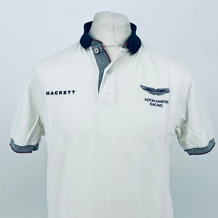 White polo shirt with navy collar and Aston Martin Racing chest emblem