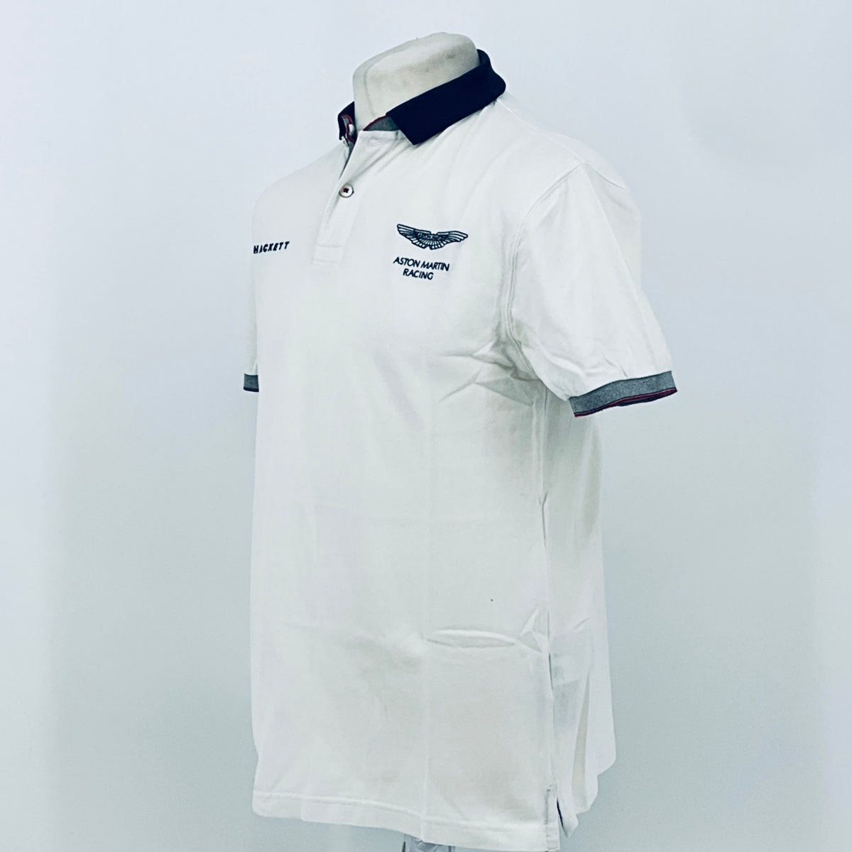 White polo shirt back view with navy collar and sleeve trim
