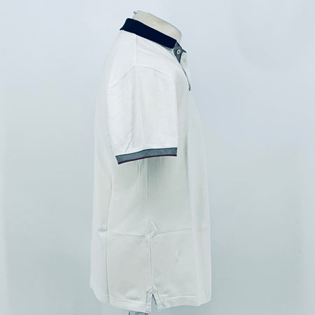 White polo shirt back/side view with navy collar and dark stripe sleeve hem