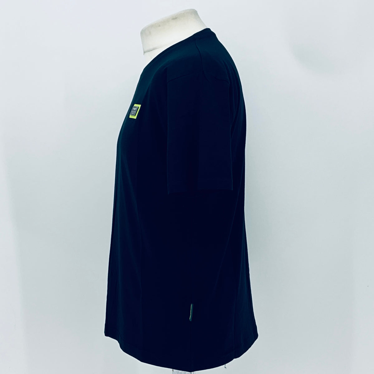 Navy short-sleeve T-shirt, side profile with small sleeve logo patch