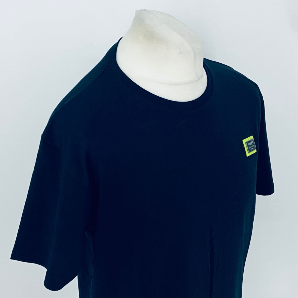 Navy short-sleeve T-shirt with small right-chest patch logo