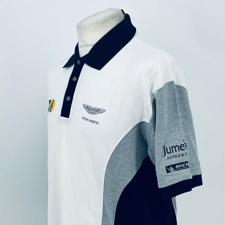 White polo shirt with navy collar, gray sleeve panel, Aston Martin chest logo