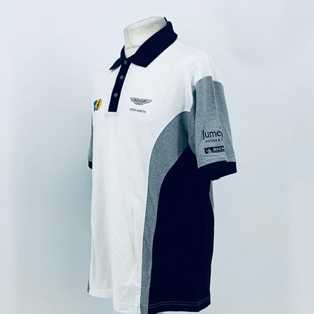 White polo shirt with navy collar, side view, gray sleeve panel with Jumeirah and MICHELIN patch