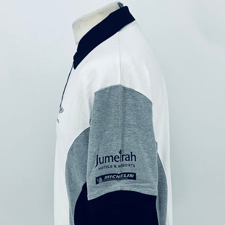 White polo shirt with gray sleeve patch reading Jumeirah Hotels & Resorts and MICHELIN