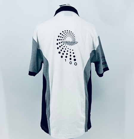 Back of white polo shirt with navy collar, gray sleeves, large dotted Aston Martin logo