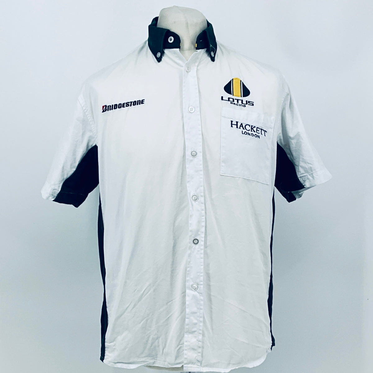 White short-sleeve button shirt with dark collar and front chest logos