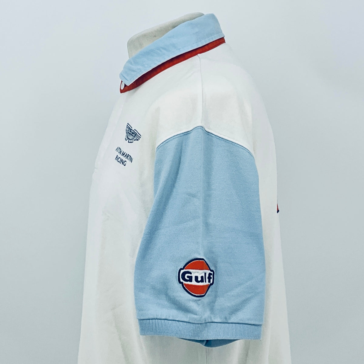 AMR Aston Martin Racing Le Mans team polo shirt, side view with red-trim collar and Gulf patch