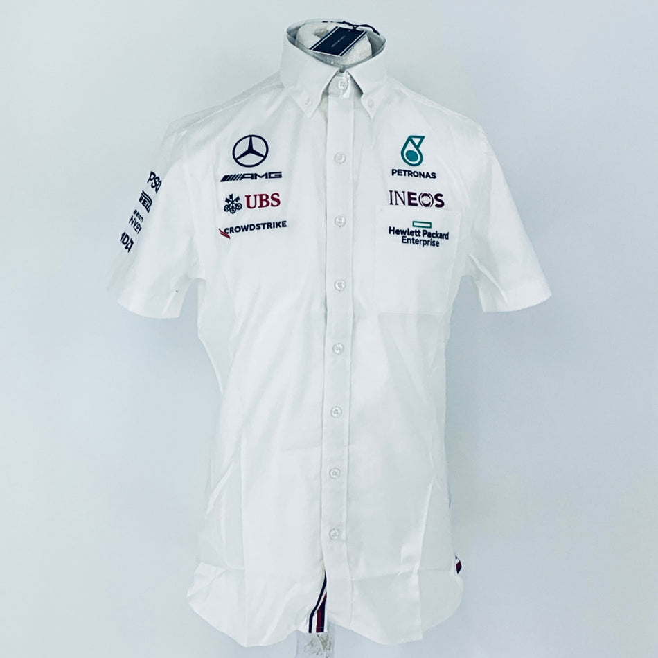 White team racing shirt front with button placket and multiple sponsor patches