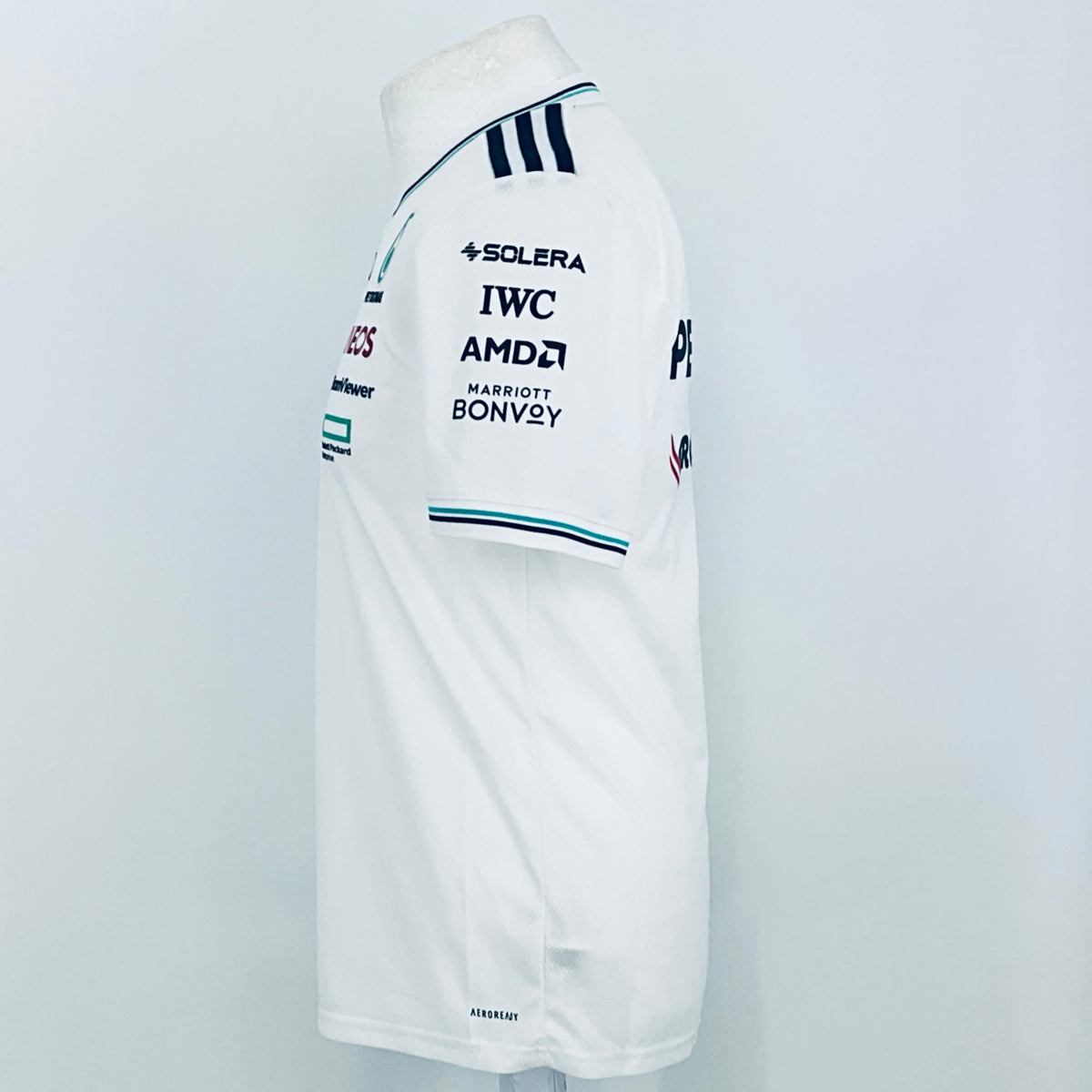 White team driver t-shirt sleeve with SOLERA, IWC, AMD, and BONVOY sponsor prints