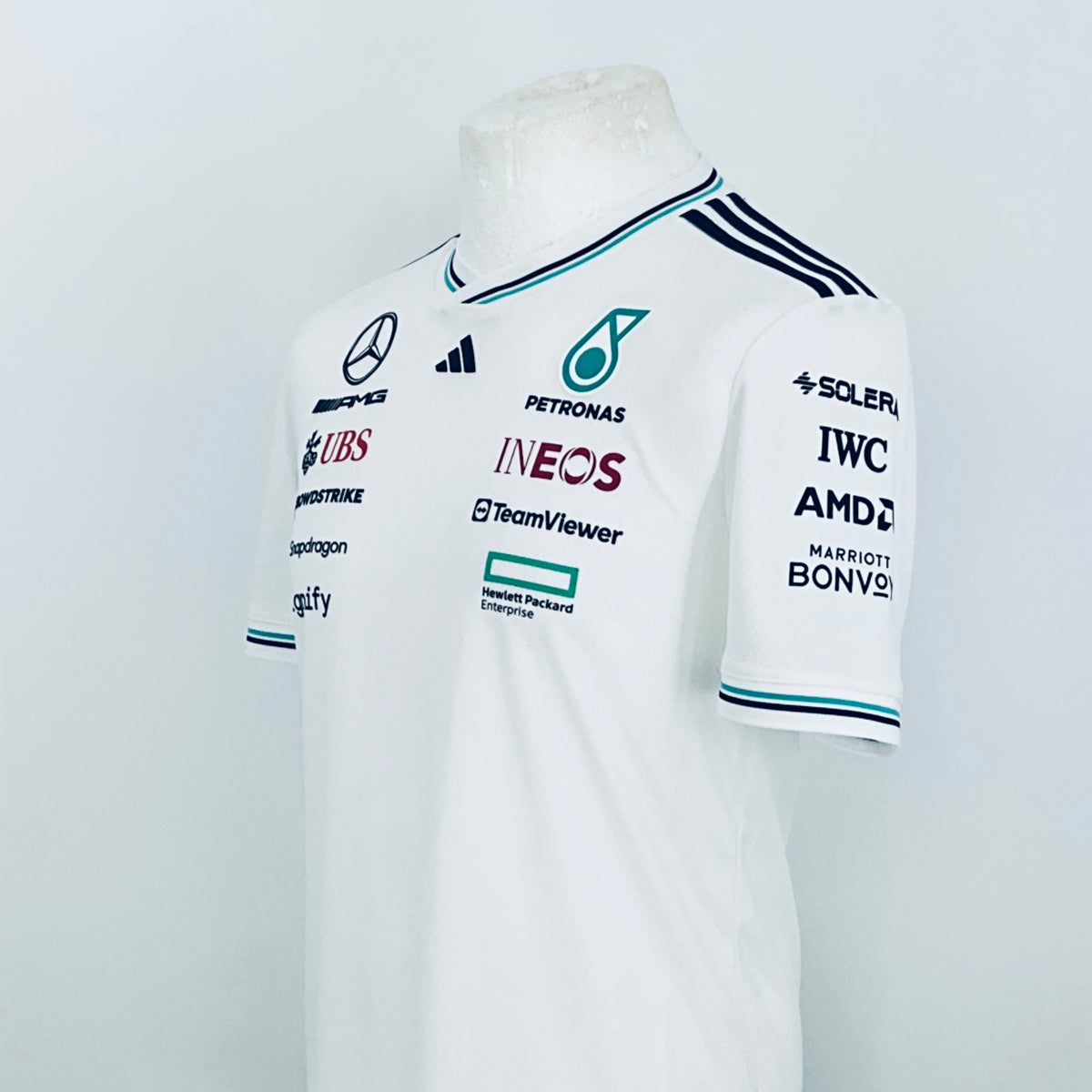 White team driver t-shirt, front side view with multiple sponsor logos and badges