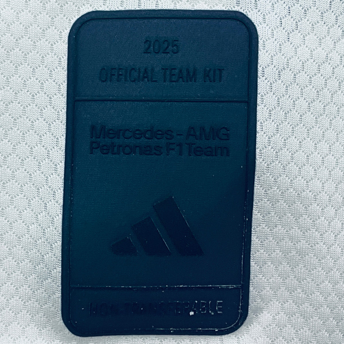 Dark blue woven patch label with embossed 2025 official team kit text