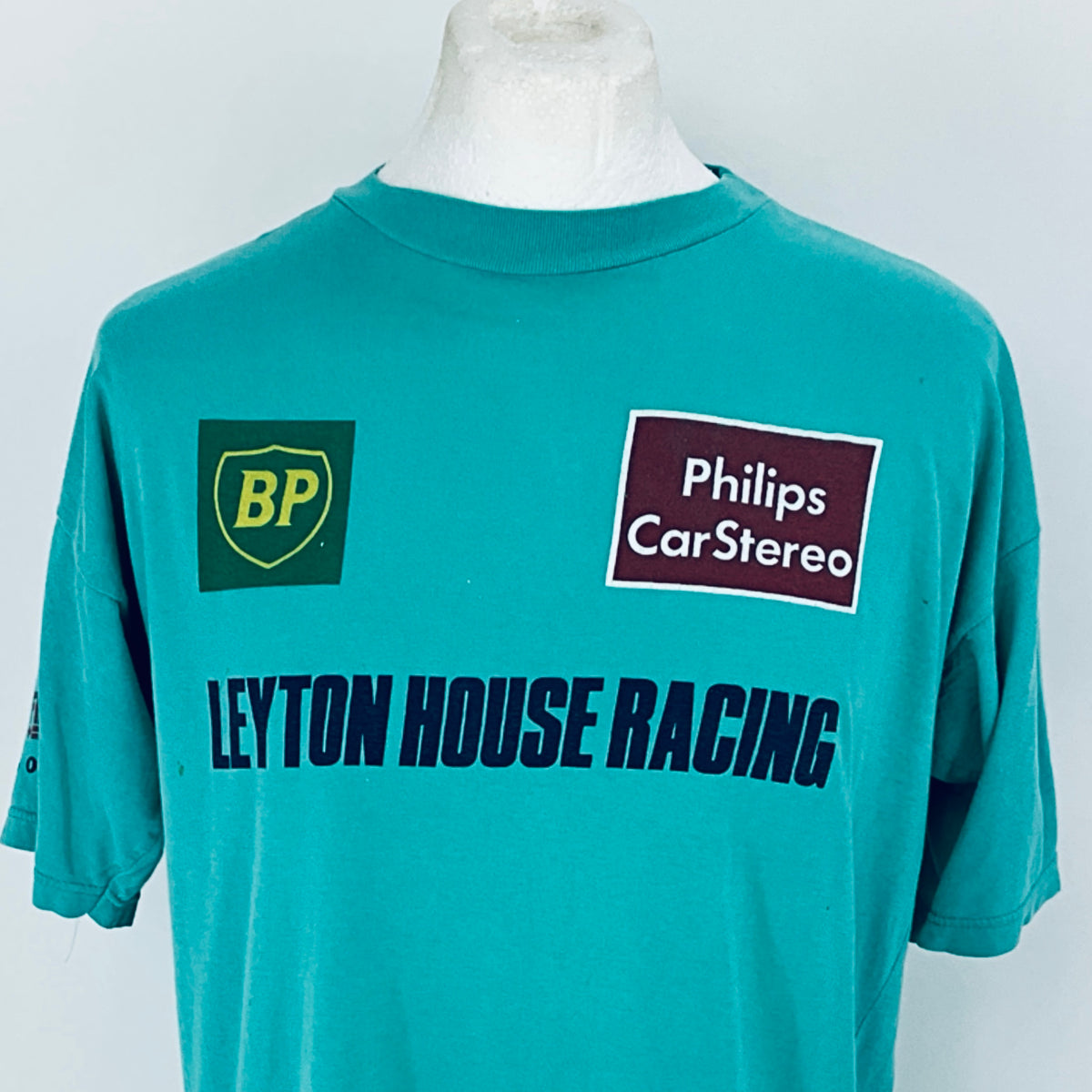 Teal t-shirt with 'BP', 'Philips CarStereo', and 'LEYTON HOUSE RACING' logos on a mannequin against a white background.