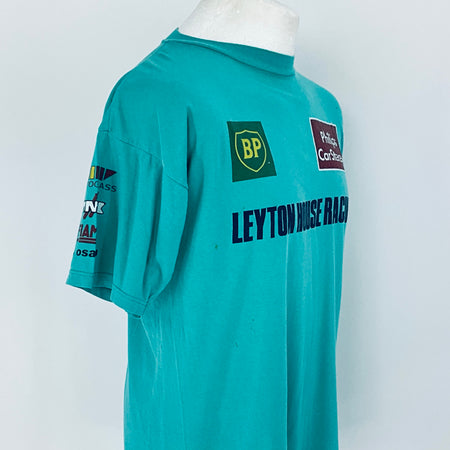 Teal racing shirt with various logos on a white background