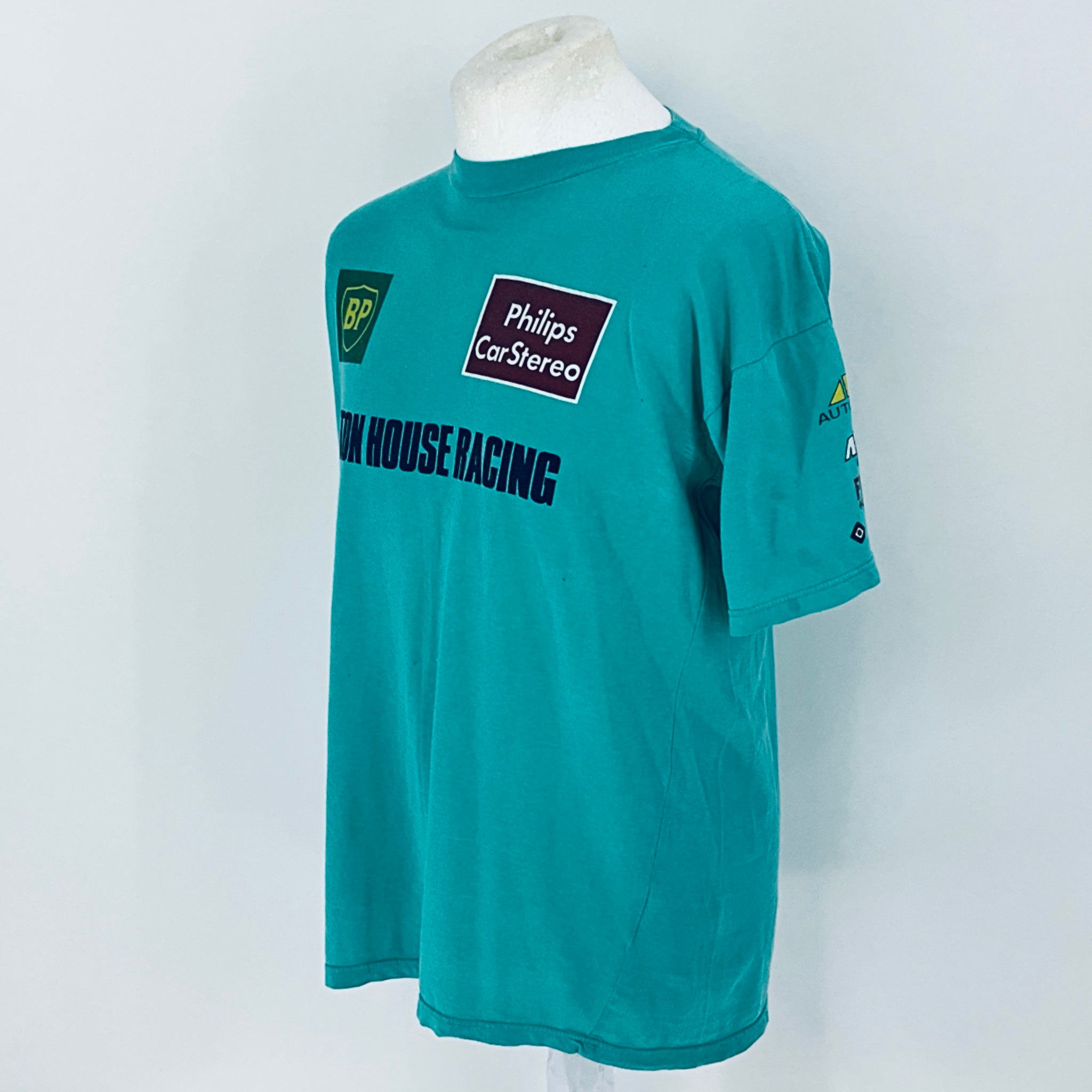 Teal t-shirt with branding on a white background