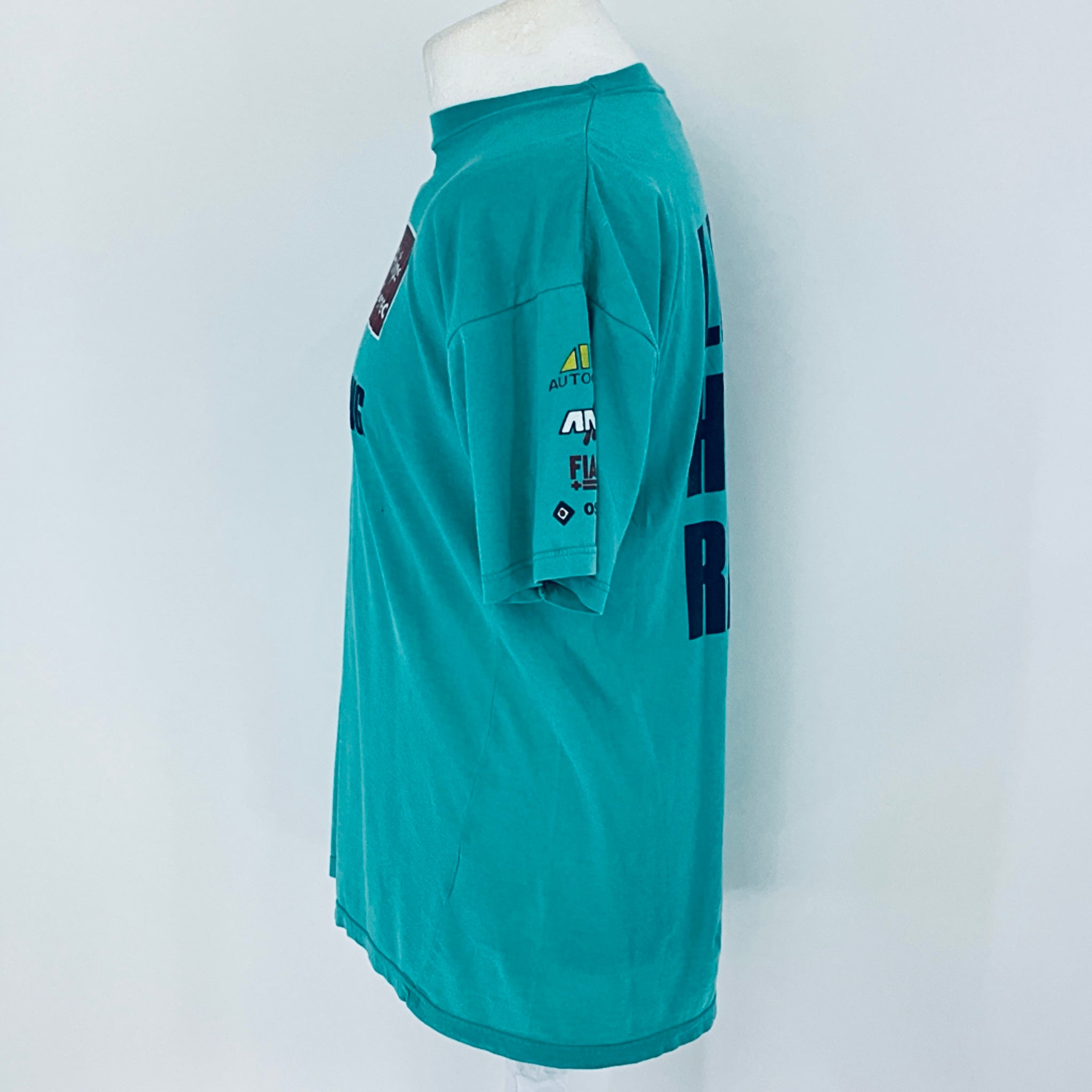 Teal t-shirt with branding on a white background