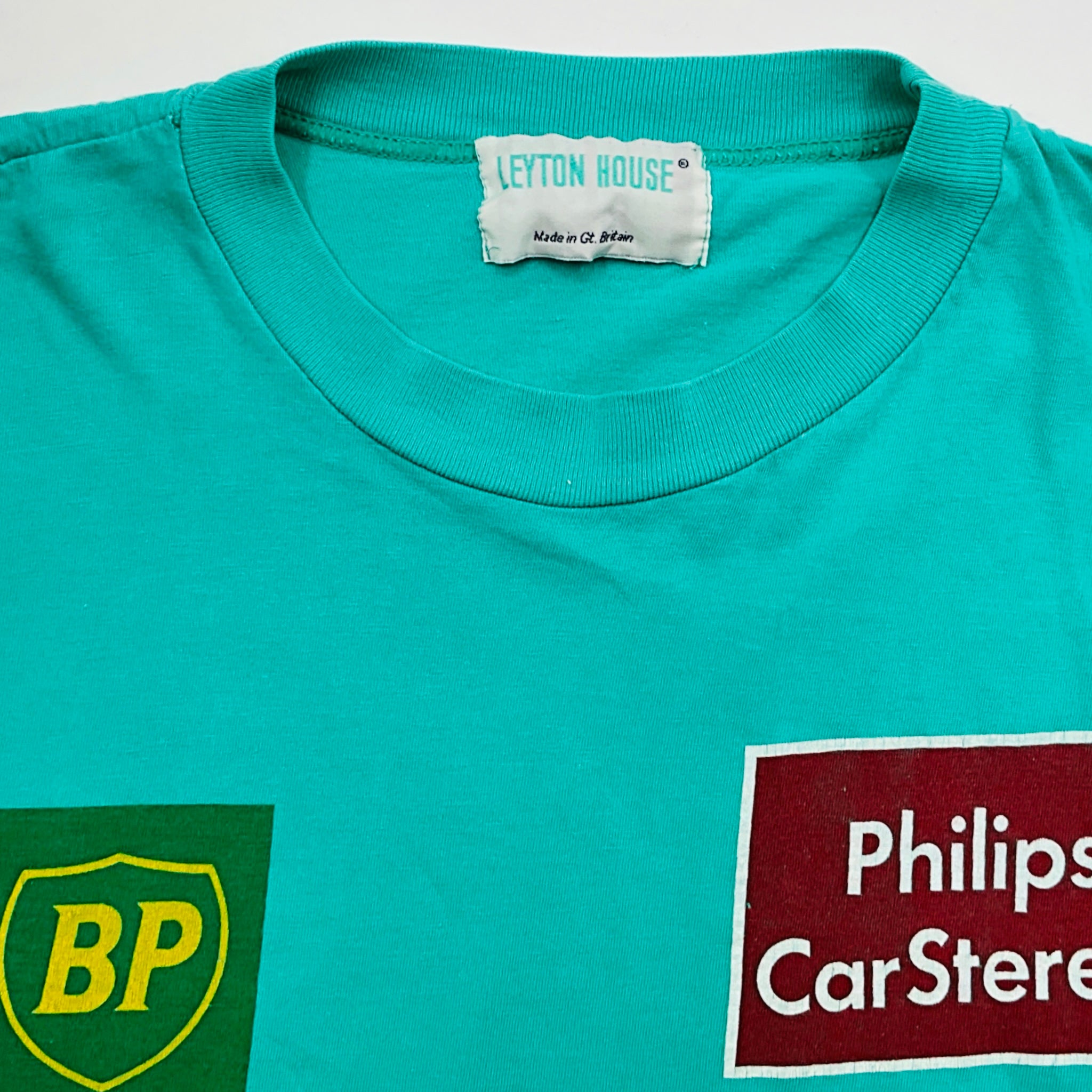 Teal t-shirt with BP logo and Philips Car Stereo label on a white background
