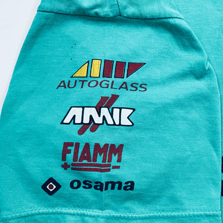 Teal jacket with logos of Autoglass, AAIK, Fiamm, and Osama on a white background