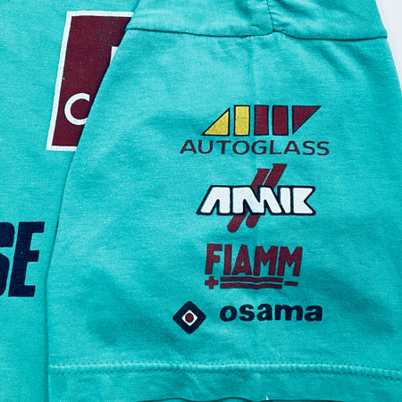 Teal jacket with logos of Autoglass, Amik, Fiamm, and Osama on a white background