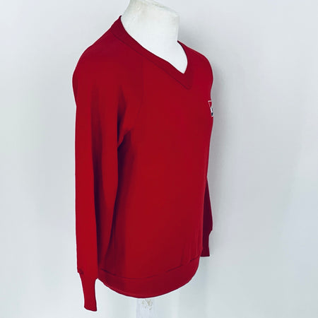 Red sweater on a mannequin against a white background