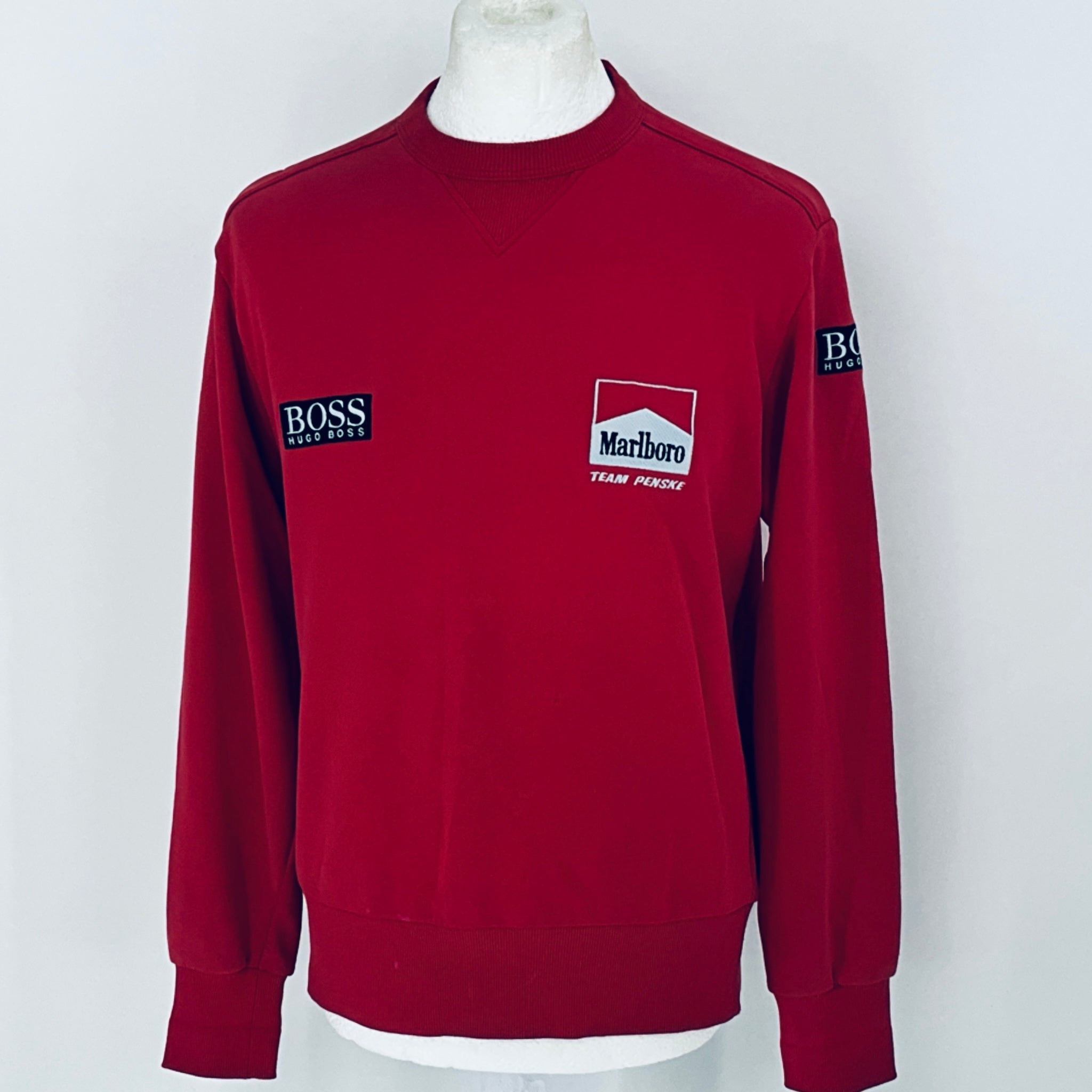 Red sweatshirt with logos on a white background