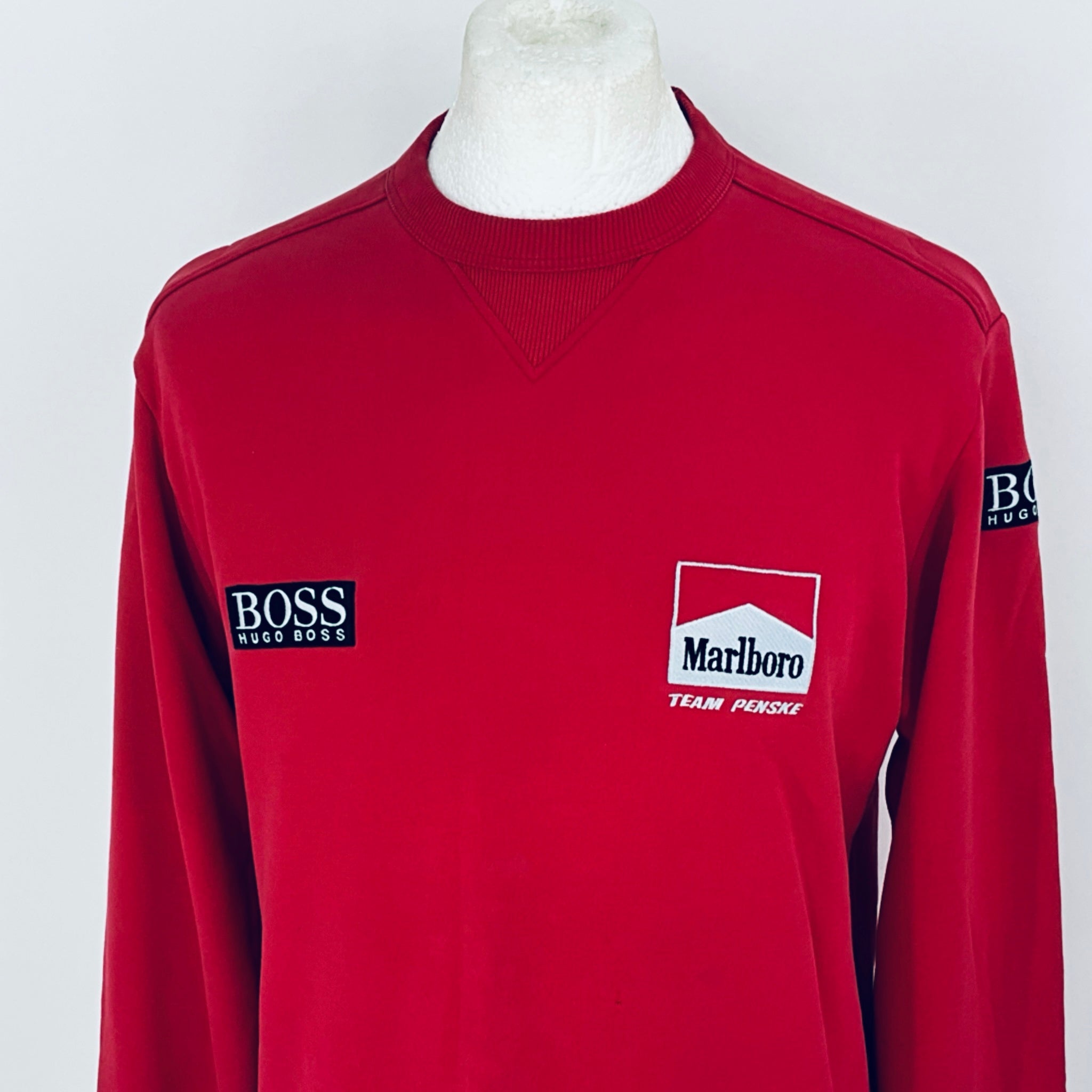 Red sweatshirt with 'BOSS' and 'Marlboro' logos on a white background