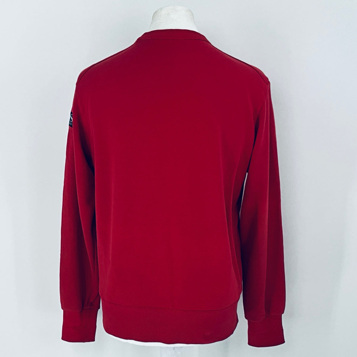 Red sweatshirt on a mannequin against a white background